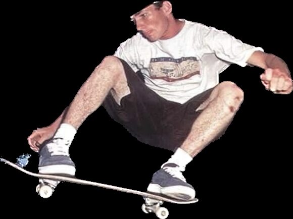 Reference photograph of a skateboarder crouched low grabbing the board mid trick